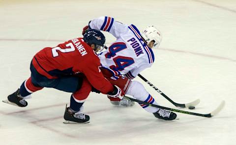 WASHINGTON, DC – MARCH 28: Washington Capitals defenseman Matt Niskanen (2) checks New York Rangers defenseman Neal Pionk (44) during a NHL game between the Washington Capitals and the New York Rangers on March 28, 2018, at Capital One Arena in Washington D.C. The Capitals defeated the Rangers 3-2 in overtime.(Photo by Tony Quinn/Icon Sportswire via Getty Images)