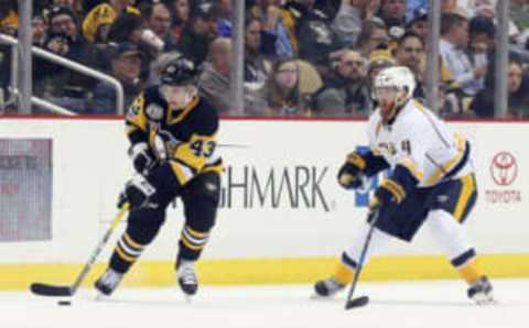 Jan 31, 2017; Pittsburgh, PA, USA; Pittsburgh Penguins left wing Conor Sheary (43) handles the puck against Nashville Predators defenseman Ryan Ellis (4) during the third period at the PPG PAINTS Arena. The Penguins won 4-2. Mandatory Credit: Charles LeClaire-USA TODAY Sports