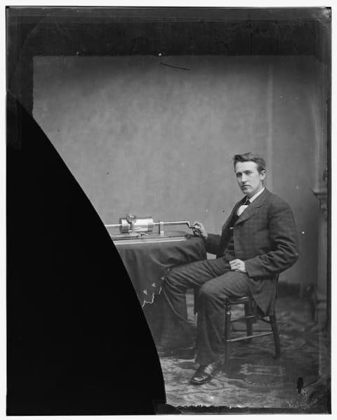 A photograph of a young Thomas Edison with an early version of the phonograph.