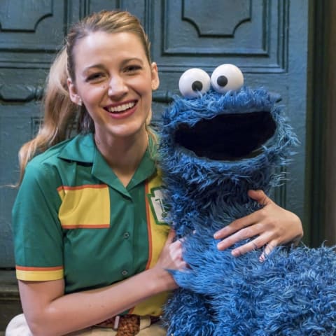 Actress Blake Lively (L) poses with Cookie Monster.