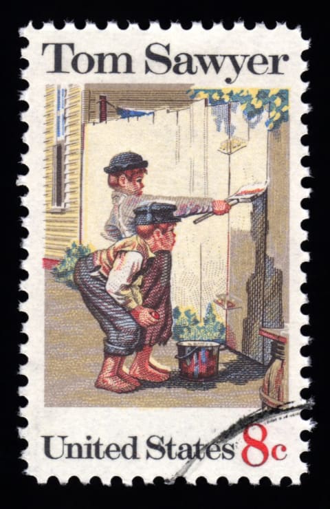 A scene from Mark Twain's novel 'The Adventures of Tom Sawyer' immortalized on a postage stamp.