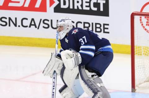 WINNIPEG, MB – DECEMBER 17: Goaltender Connor Hellebuyck #37 of the Winnipeg Jets guards the net during second period action against the Carolina Hurricanes at the Bell MTS Place on December 17, 2019 in Winnipeg, Manitoba, Canada. The Canes defeated the Jets 6-3. (Photo by Darcy Finley/NHLI via Getty Images)