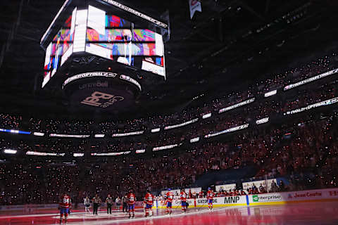 The Tampa Bay Lightning and the Montreal Canadiens stand at attention prior to Game Three of the 2021 NHL Stanley Cup Final. (Photo by Bruce Bennett/Getty Images)