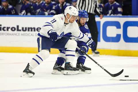 Oct 21, 2023; Tampa, Florida, USA; Toronto Maple Leafs center Max Domi (11) and Tampa Bay Lightning center Anthony Cirelli (71) battle for the puck in the first period at Amalie Arena. Mandatory Credit: Nathan Ray Seebeck-USA TODAY Sports