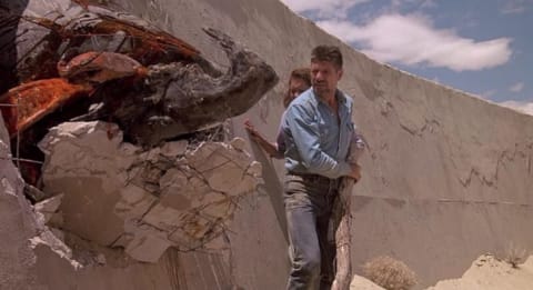 Fred Ward with Finn Carter in Tremors (1990).