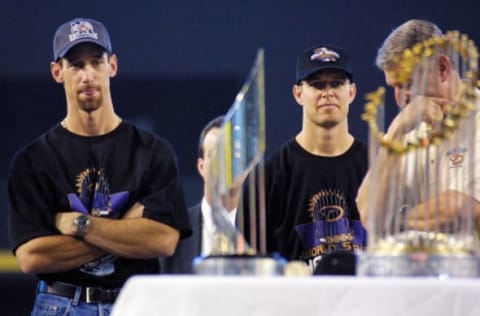 PHOENIX, AZ – NOVEMBER 7: Arizona Diamondbacks’ Luis Gonzalez (L), Jay Bell (C) and managing general partner Jerry Colangelo (R) attend a victory rally 07 November 2001 at Bank One Ballpark in Phoenix, AZ. In the foreground is the World Series trophy (R) and the MVP trophy presented to Diamondbacks’ Randy Johnson and Curt Schilling. Gonzalez hit the winning RBI and Bell scored the winning run in game seven against the New York Yankees to win the 2001 World Series. (Photo credit should read MIKE FIALA/AFP/Getty Images)