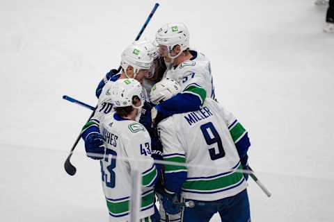 Dec 16, 2021; San Jose, California, USA; Vancouver Canucks center J.T. Miller (9), defenseman Quinn Hughes (43), defenseman Tyler Myers (57) and left wing Tanner Pearson (70) celebrate after a goal during the third period against the San Jose Sharksat SAP Center at San Jose. Mandatory Credit: Neville E. Guard-USA TODAY Sports