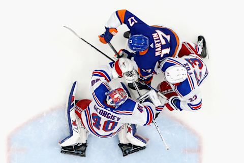 Adam Fox #23 and Alexandar Georgiev #40 of the New York Rangers defend the net against Matt Martin #17 of the New York Islanders (Photo by Bruce Bennett/Getty Images)