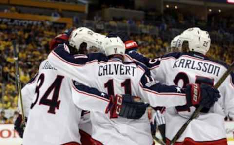 Apr 12, 2017; Pittsburgh, PA, USA; Columbus Blue Jackets left wing Matt Calvert (11) celebrates with teammates after scoring a goal against the Pittsburgh Penguins during the third period in game one of the first round of the 2017 Stanley Cup Playoffs at PPG PAINTS Arena. The Penguins won 3-1. Mandatory Credit: Charles LeClaire-USA TODAY Sports