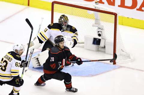 Sebastian Aho #20 of the Carolina Hurricanes attempts to deflect the puck past Jaroslav Halak #41 of the Boston Bruins  (Photo by Elsa/Getty Images)