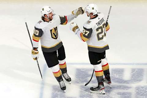 Shea Theodore #27 is congratulated by his teammate Chandler Stephenson #20. (Photo by Jeff Vinnick/Getty Images)