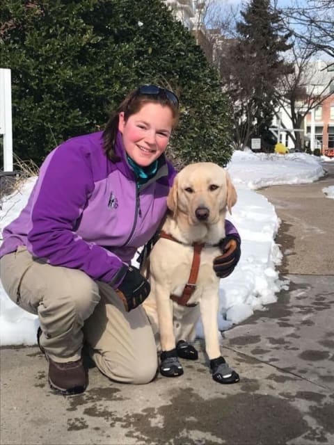 Seeing Eye instructor Ruthanne Dewy with a yellow Lab she trained.