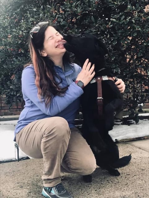 Seeing Eye instructor Sarah Indano with a black Lab she trained.