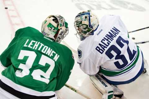 Oct 29, 2015; Dallas, TX, USA; Dallas Stars goalie Kari Lehtonen (32) talks with former teammate Vancouver Canucks goalie Richard Bachman (32) before the game at the American Airlines Center. Mandatory Credit: Jerome Miron-USA TODAY Sports