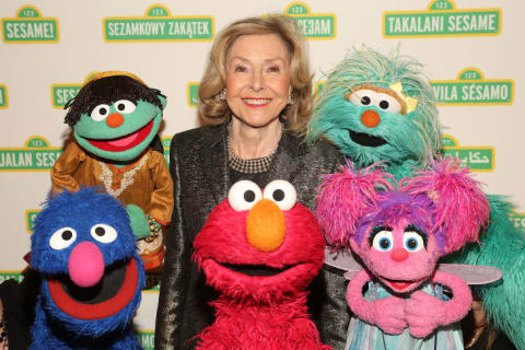 Joan Ganz Cooney and the Sesame Street Muppets.