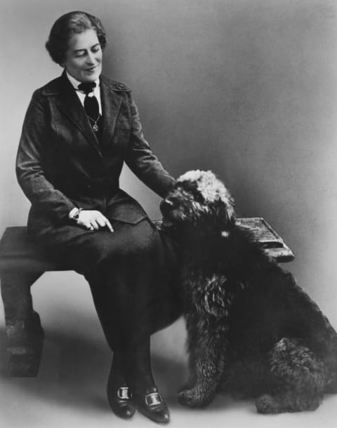 Juliette Gordon Low, founder of the Girl Scouts, with a dog, circa 1915.