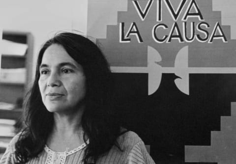 Dolores Huerta with a union flag in the 1970s.