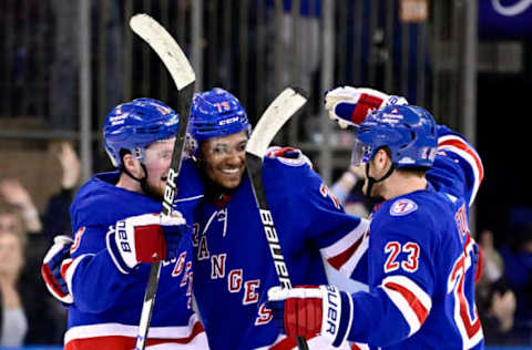 NEW YORK, NEW YORK – FEBRUARY 15: K’Andre Miller #79 of the New York Rangers is congratulated by Alexis Lafreniere #13 and Adam Fox #23 after scoring the game-winning shootout goal against the Boston Bruins at Madison Square Garden on February 15, 2022, in New York City. (Photo by Steven Ryan/Getty Images)