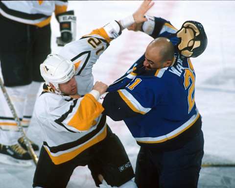 2001 Season: Billy Tibbetts of the Penguins goes at it with Jamal Mayers of the Blues. (Photo by Jim McIsaac/Getty Images)