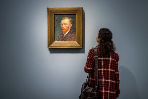 A woman admires Vincent van Gogh's 'Self-Portrait,' which was painted in 1853.