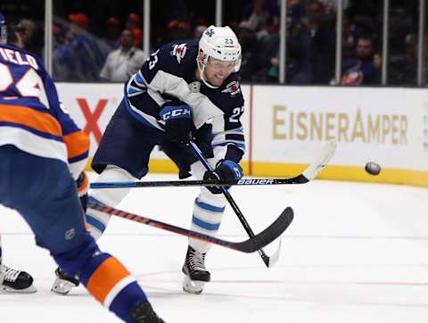 Carl Dahlstrom #23 of the Winnipeg Jets scales the puck into the New York Islanders end. (Photo by Bruce Bennett/Getty Images)