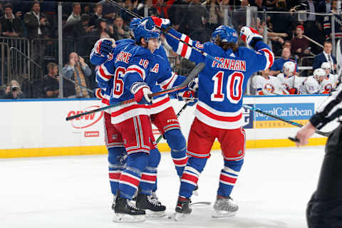 Jesper Fast #17, Ryan Strome #16 and Artemi Panarin #10 of the New York Rangers celebrate