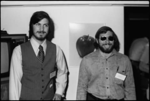 Steve Jobs (left) and Steve Wozniak (right) attend San Francisco's West Coast Computer Faire in 1977 for the debut of the Apple II, a milestone for personal computers.