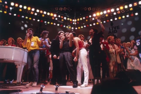 George Michael, Bob Geldof, Bono, Paul McCartney, Freddie Mercury, David Bowie, and Howard Jones gather together for the Live Aid finale at London's Wembley Stadium.