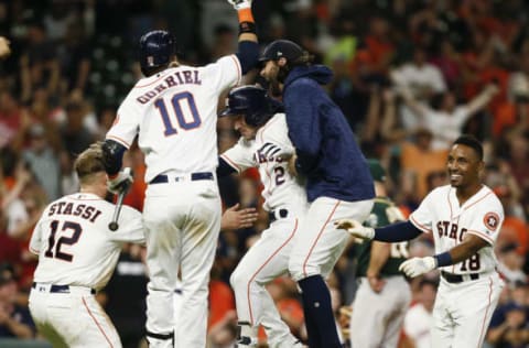 HOUSTON, TX – JULY 10: Alex Bregman #2 of the Houston Astros celebrates with Yuli Gurriel #10, Jake Marisnick #6, Max Stassi #12 and Tony Kemp #18 after singling in the winning run in the eleventh inning against the Oakland Athletics at Minute Maid Park on July 10, 2018 in Houston, Texas. (Photo by Bob Levey/Getty Images)