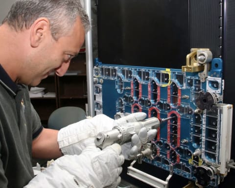 Astronaut Mike Massimino practices repairing a portion of the Hubble Space Telescope while training at NASA's Johnson Space Center in Houston, Texas.