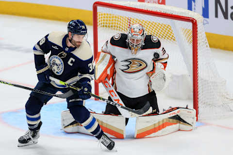 Jan 19, 2023; Columbus, Ohio, USA; Columbus Blue Jackets center Boone Jenner (38) deflects the puck against Anaheim Ducks goaltender John Gibson (36) in the third period at Nationwide Arena. Mandatory Credit: Aaron Doster-USA TODAY Sports