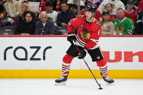 CHICAGO, ILLINOIS – APRIL 07: Jake McCabe #6 of the Chicago Blackhawks skates with the puck against the Seattle Kraken in the first period at United Center on April 07, 2022 in Chicago, Illinois. (Photo by Patrick McDermott/Getty Images)