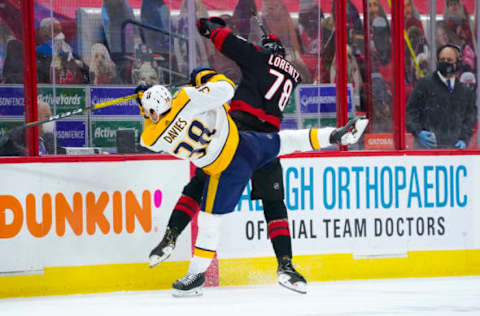 Mar 11, 2021; Raleigh, North Carolina, USA; Carolina Hurricanes left wing Steven Lorentz (78) checks Nashville Predators defenseman Jeremy Davies (38) during the second period at PNC Arena. Mandatory Credit: James Guillory-USA TODAY Sports