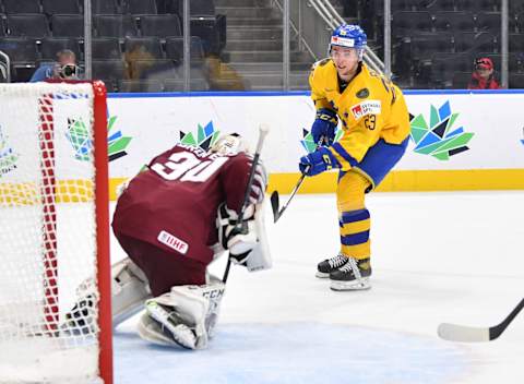 EDMONTON, AB – AUGUST 17: Isak Rosen #23 of Sweden takes a shot on Bruno Bruveris #30 of Latvia in the IIHF World Junior Championship on August 17, 2022 at Rogers Place in Edmonton, Alberta, Canada (Photo by Andy Devlin/ Getty Images)