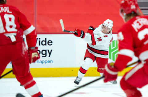 Jan 16, 2021; Detroit, Michigan, USA; Carolina Hurricanes center Ryan Dzingel (18) attempts a shot on goal against the Detroit Red Wings at Little Caesars Arena. Mandatory Credit: Eric Bronson-USA TODAY Sports