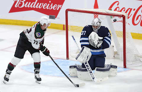 Arizona Coyotes, Travis Boyd (72), Winnipeg Jets, Connor Hellebuyck (37). (Photo by Jason Halstead/Getty Images)