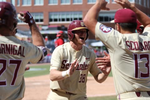 DURHAM, NC – MAY 27: Florida State catcher Casey Cribb (28) and Florida State pitcher Jonah Scolaro (13) celebrate a home run during the ACC Baseball Championship game between the Florida State and the Louisville Cardinals on May 27, 2018, at Durham Bulls Stadium in Durham, NC. (Photo by Jaylynn Nash/Icon Sportswire via Getty Images)