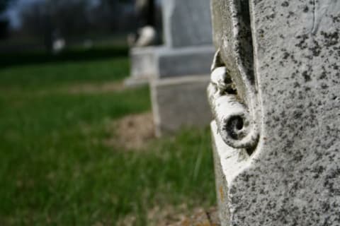 Scrolls on a tombstone can refer to an unknown future.