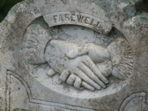 Hands on a tombstone can mean several things.