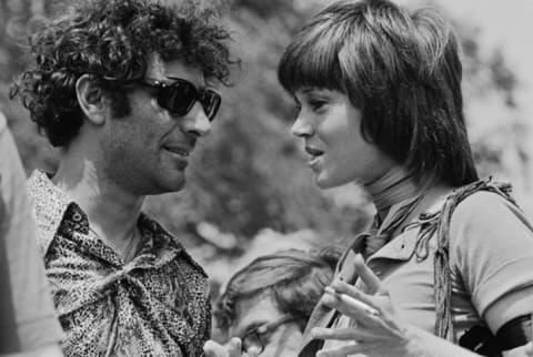 Political activists Abbie Hoffman and Jane Fonda talk at a 1970 demonstration in Washington, D.C., protesting the recent violence used to breakup a Vietnam War protest at Kent State University.