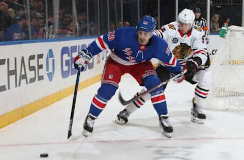 NEW YORK, NY – JANUARY 17: Chris Kreider #20 of the New York Rangers skates with the puck against Connor Murphy #5 of the Chicago Blackhawks at Madison Square Garden on January 17, 2019 in New York City. The New York Rangers won 4-3. (Photo by Jared Silber/NHLI via Getty Images)