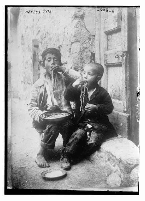 Two Neapolitan boys eating plates of pasta, date unknown.