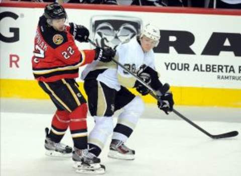 Jan 11, 2014; Calgary, Alberta, CAN; Calgary Flames right wing Lee Stempniak (22) battles with Pittsburgh Penguins left wing Jussi Jokinen (36) at Scotiabank Saddledome. Penguins won 2-1. Mandatory Credit: Candice Ward-USA TODAY Sports