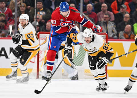 MONTREAL, CANADA – DECEMBER 13: Joel Armia #40 of the Montreal Canadien jumps over Sidney Crosby #87 of the Pittsburgh Penguins during the third period at the Bell Centre on December 13, 2023 in Montreal, Quebec, Canada. The Pittsburgh Penguins defeated the Montreal Canadiens 4-3 in a shootout. (Photo by Minas Panagiotakis/Getty Images)