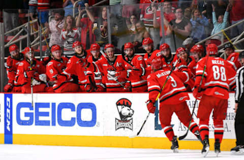 CHARLOTTE, NC – JUNE 01: The bench high fives Charlotte Checkers defenseman Roland McKeown (3) after his goal during game one of the Calder Cup finals between the Chicago Wolves and the Charlotte Checkers on June 01, 2019 at Bojangles Coliseum in Charlotte,NC.(Photo by Dannie Walls/Icon Sportswire via Getty Images)