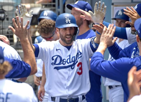 Jul 25, 2021; Los Angeles, California, USA; Los Angeles Dodgers left fielder Chris Taylor (3) is congratulated in the dugout after hitting a solo home run in the first inning of the game against the Colorado Rockies at Dodger Stadium. Mandatory Credit: Jayne Kamin-Oncea-USA TODAY Sports