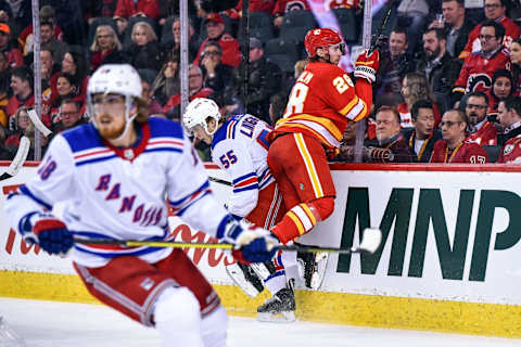 CALGARY, AB – JANUARY 02: Calgary Flames Center Elias Lindholm (28) bodychecks New York Rangers Defenceman Ryan Lindgren (55)