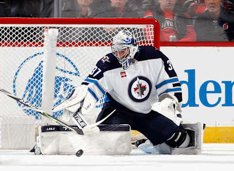 NEWARK, NEW JERSEY – FEBRUARY 19: Connor Hellebuyck #37 of the Winnipeg Jets makes the first period save against the New Jersey Devils at the Prudential Center on February 19, 2023 in Newark, New Jersey. (Photo by Bruce Bennett/Getty Images)