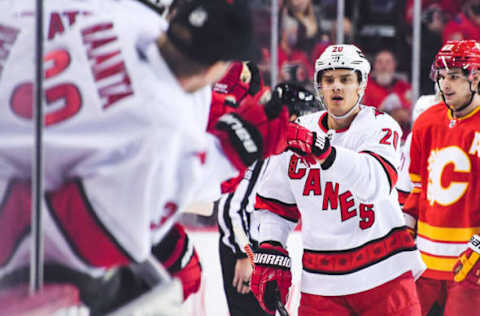 CALGARY, AB – DECEMBER 9: Sebastian Aho #20 (L) of the Carolina Hurricanes celebrates with his team after scoring against the Calgary Flames during an NHL game at Scotiabank Saddledome on December 9, 2021, in Calgary, Alberta, Canada. (Photo by Derek Leung/Getty Images)