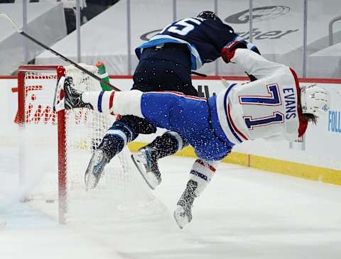 Montreal Canadiens, Jake Evans #71; Winnipeg Jets, Mark Scheifele #55. (Photo by David Lipnowski/Getty Images)